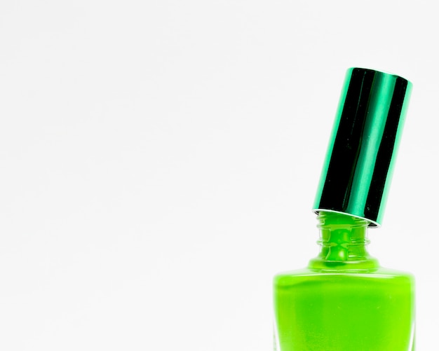 Green nail polish isolated on white background