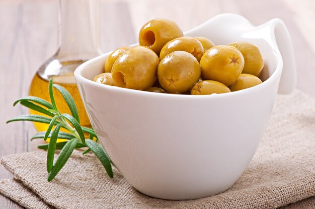 Green olive in bowl.