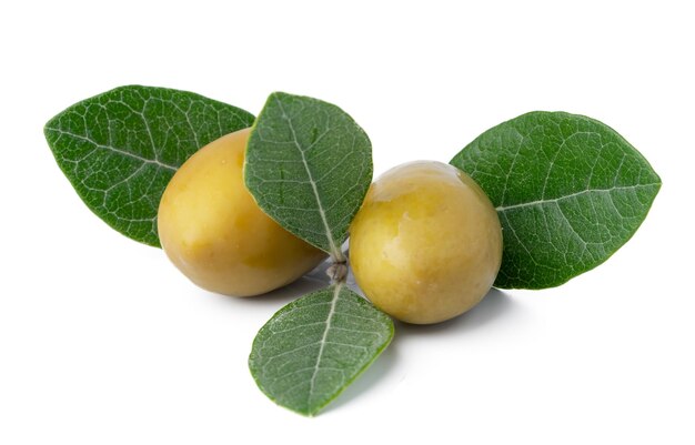 Green olives with leaves isolated on white background