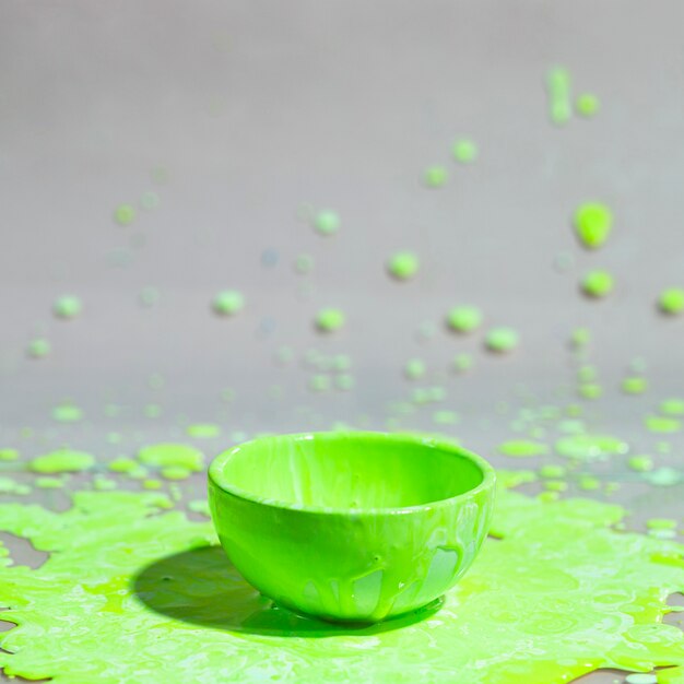 Green paint splash and cup abstract background