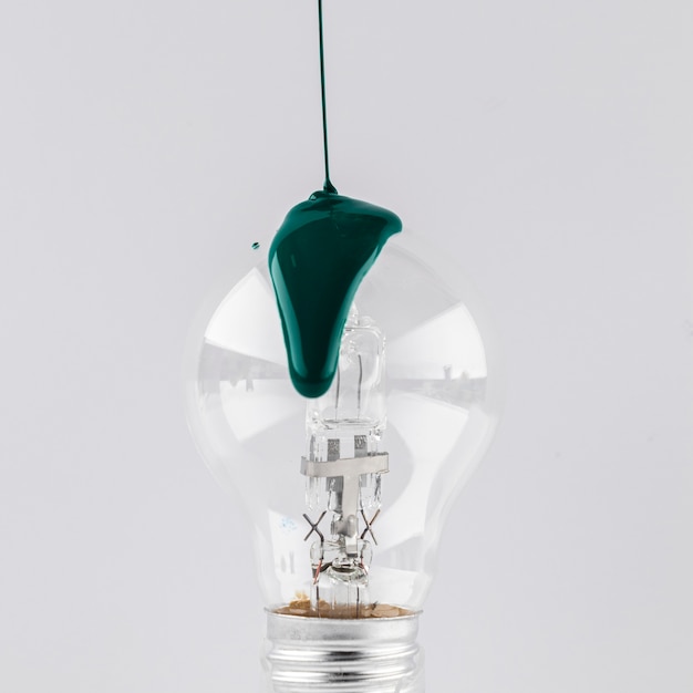 Free photo green painted poured on light bulb