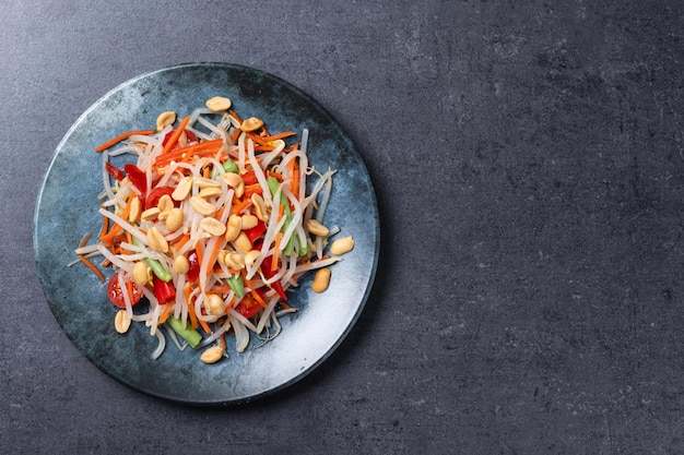 Free photo green papaya salad som tam thai on black slate background