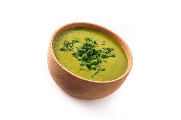 Green pea soup in a bowl isolated