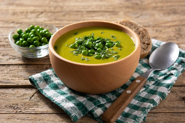 Green pea soup in a wooden bowl