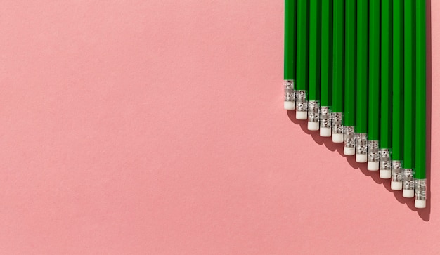 Free photo green pencils frame with copy-space