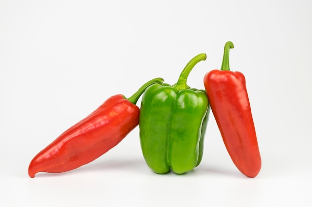 Green pepper between red peppers