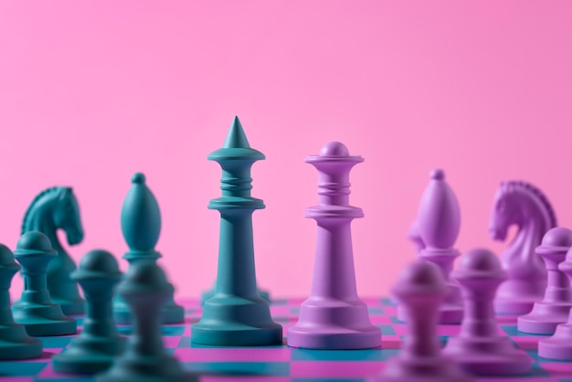 Free photo green and pink pieces for chess with game board