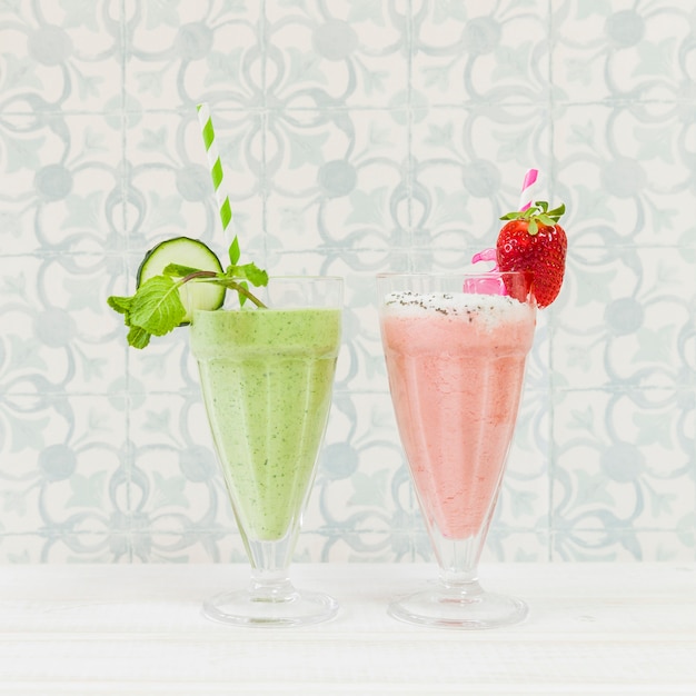 Green and pink summer smoothies with strawberry