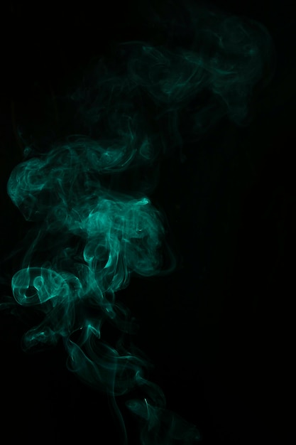 Green plume of smoke wavy swirls on black background