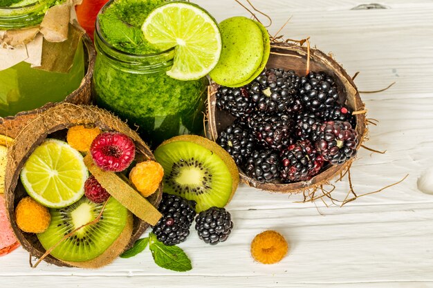 green and red smoothies in a jar with lime