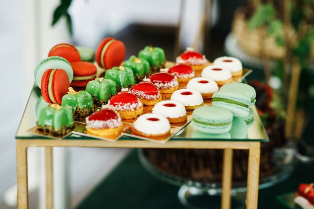 Green and red sweets served on box on candy-bar
