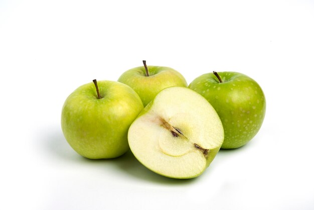 Green ripe apples on white background.