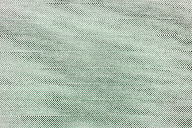 緑の敷物生地の織り目加工の背景