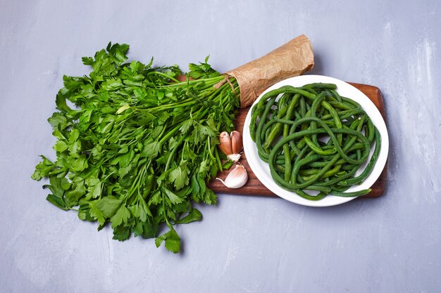 Green salad and herbs on blue