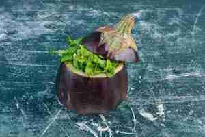 Free photo green salad inside carved eggplant.