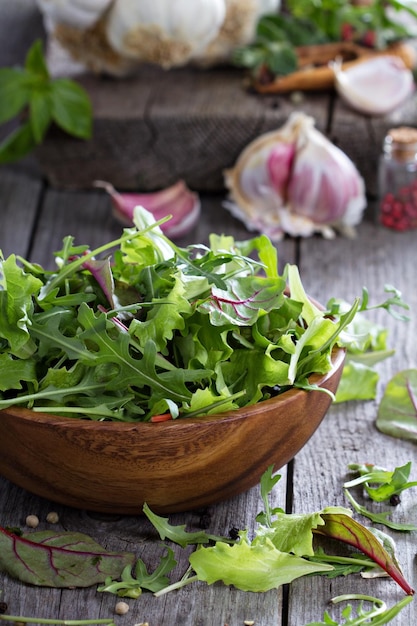 Green salad leaves in a wooden bowl