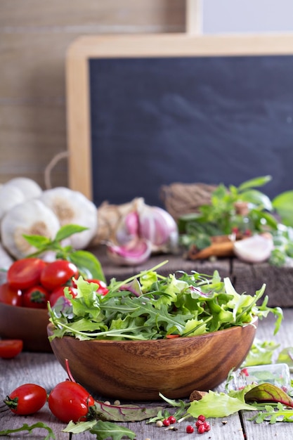 Green salad leaves in a wooden bowl