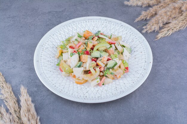 Green seasonal salad with minced and chopped vegetable in a platter