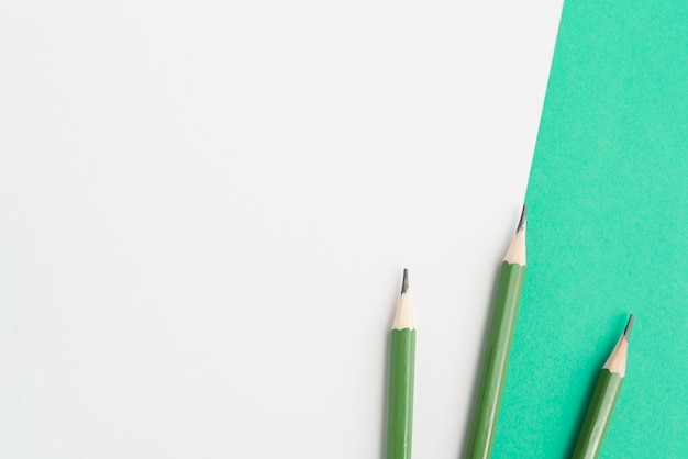 Free photo green sharp pencils on dual background