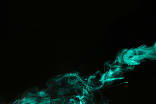 Green smoke movement on dark background