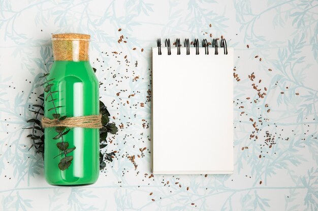 Green smoothie next to empty notepad