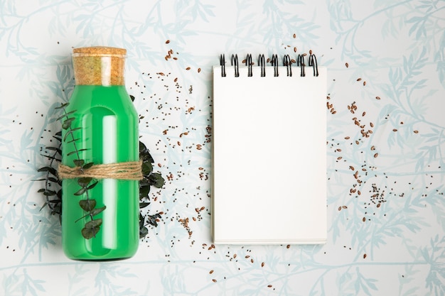 Green smoothie next to empty notepad