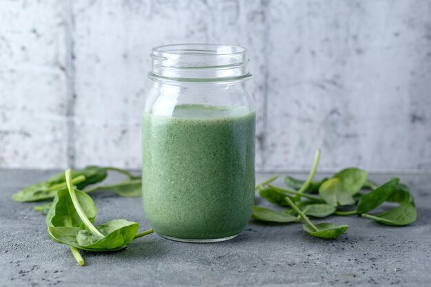 Green smoothie in jar on table