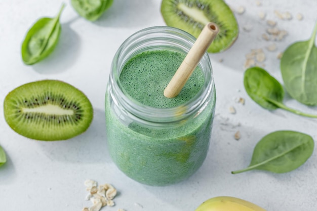 Green smoothie in jar on table