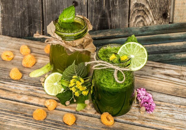 green smoothie in a jar with lime, kiwi and berry