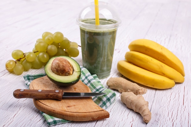 Green smoothie with bananas,lime,grape and avocado lie on the table
