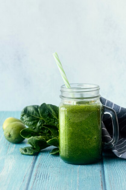 Green smoothie on wooden table