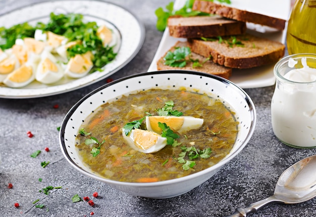 Green sorrel soup with eggs. Summer menu. Healthy food.