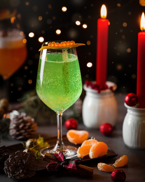 green sparkling water in christmas table with red candles