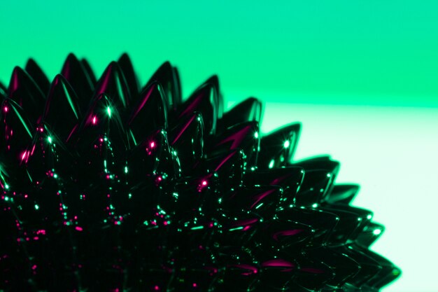 Green and spiky ferromagnetic liquid metal with copy space