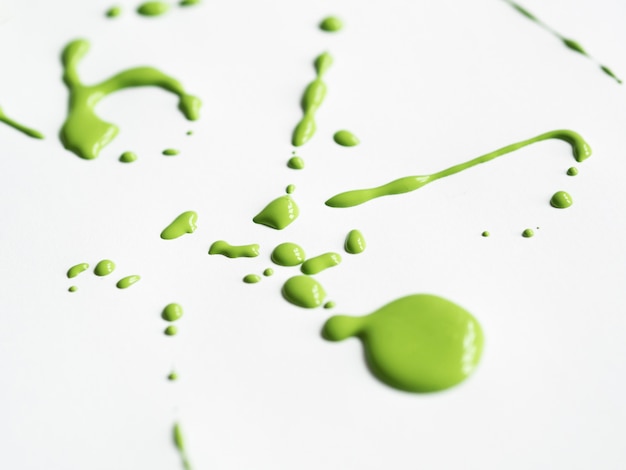 Green splash on white canvas close-up