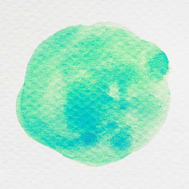 Green stained watercolor on white textured background
