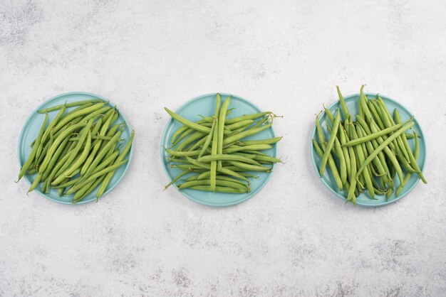 Green string beans on a textured background empty space for text vegetables