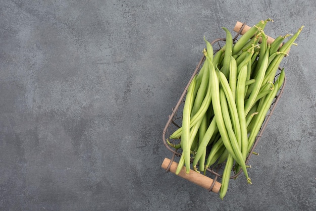 Green string beans on a textured background empty space for text vegetables