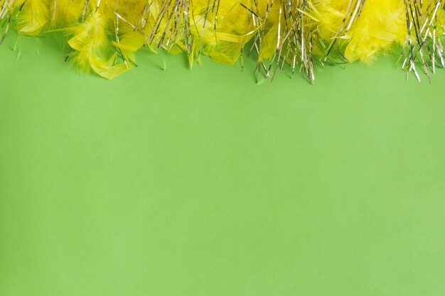 Green table with yellow feathers on top