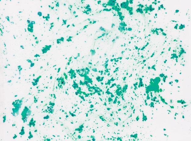 Green textured holi color powder mess on white background