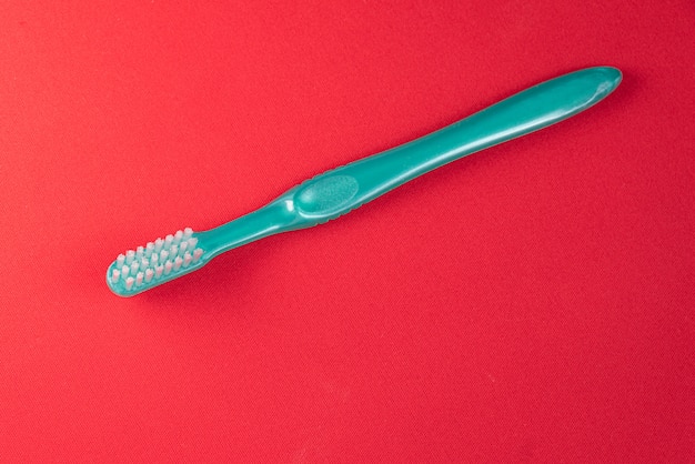 Green toothbrush on the red table