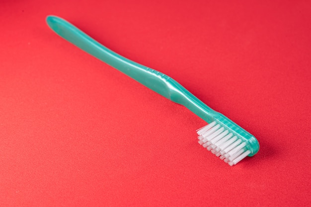 Green toothbrush on the red table