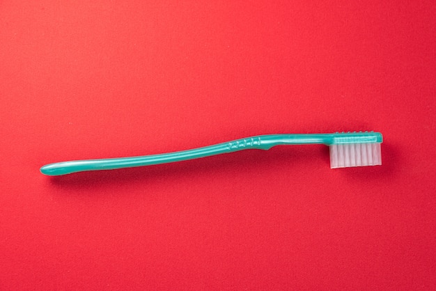 Green toothbrush on the red table