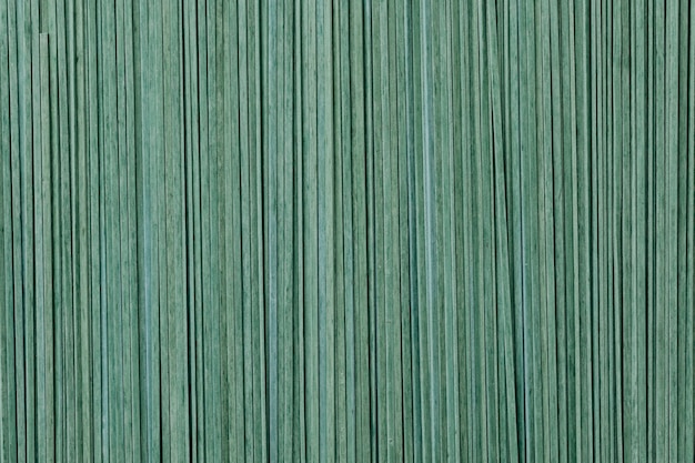 Green uncooked tagliatelle textured background