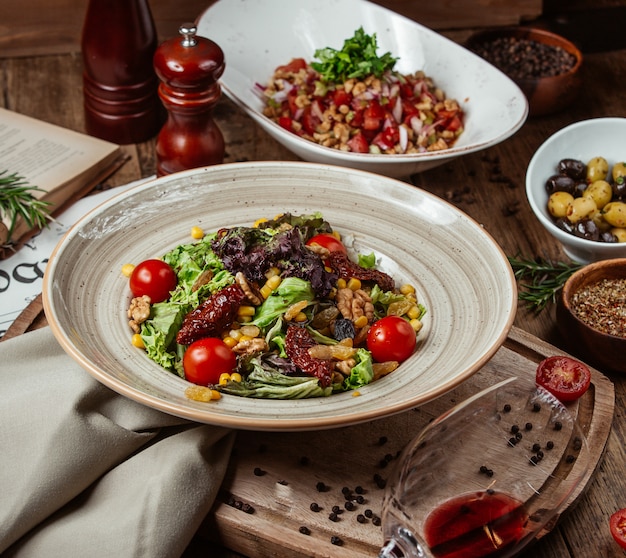 Green vegetable salad with cherry tomatoes.