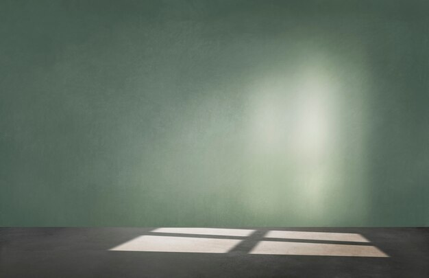 Green wall in an empty room with concrete floor