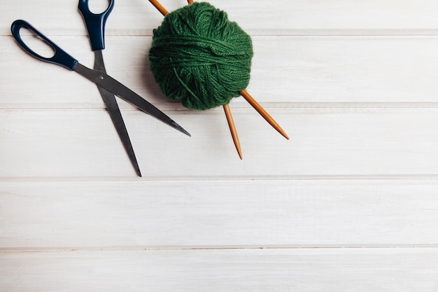 Green wool ball and scissors