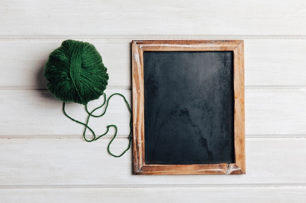 Green wool ball and slate