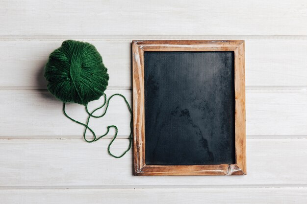 Green wool ball and slate