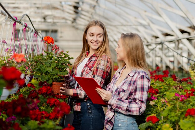 Greenhouse women employees looking at each other